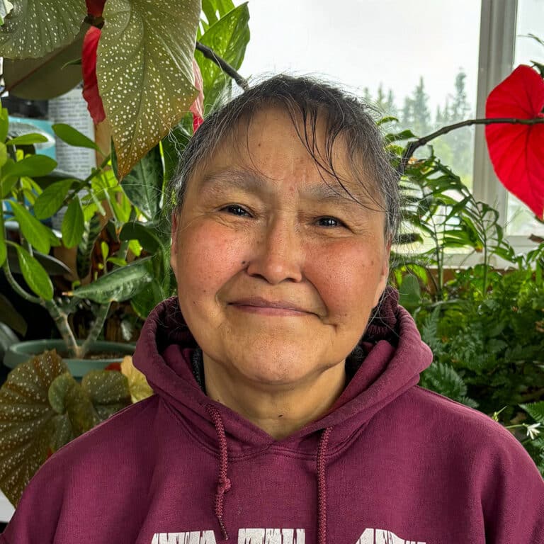 Woman in front of plants inside