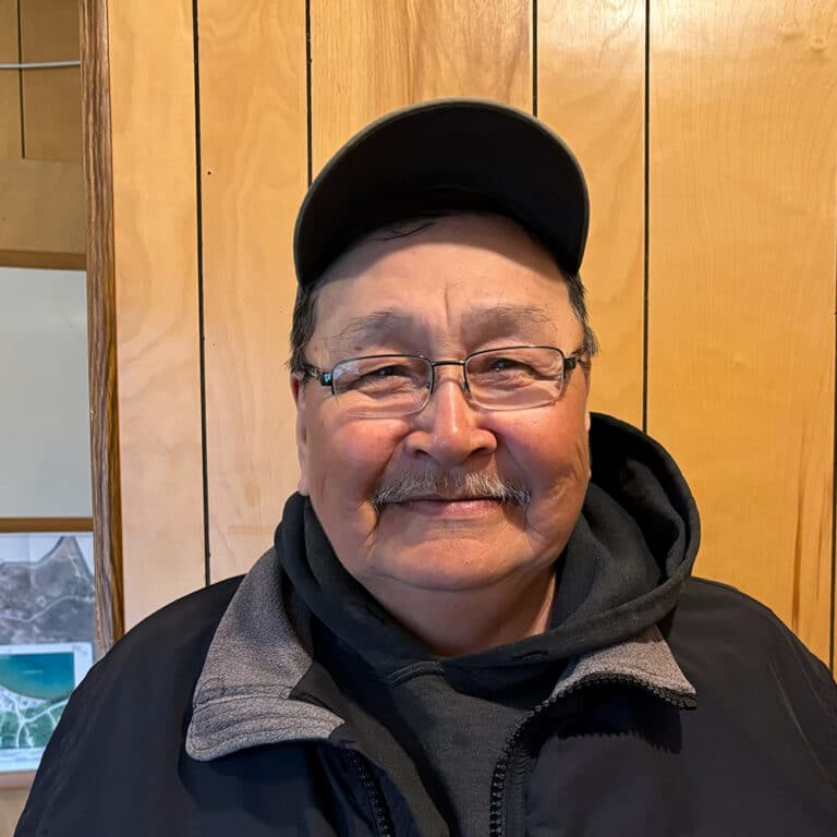 Man wearing a hat and glasses smiling